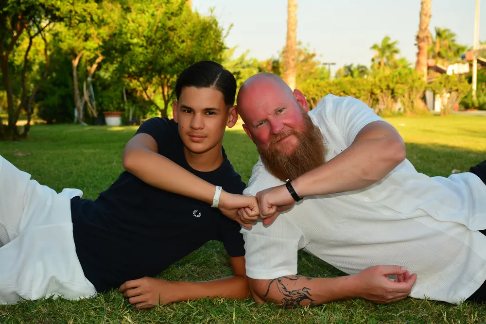 Vater und Sohn Faust an Faust im Gras